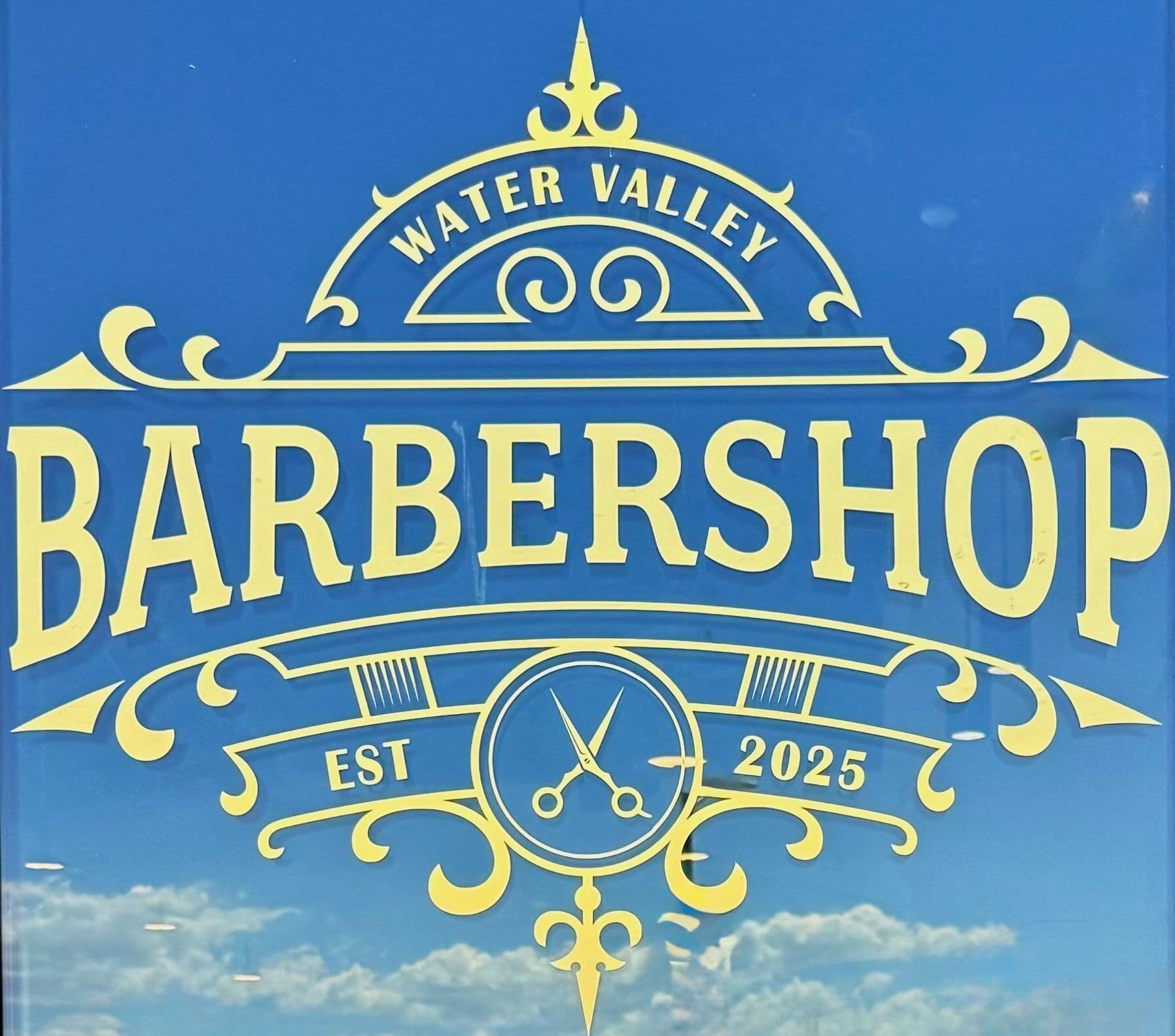 Water Valley Barbershop gold window signage