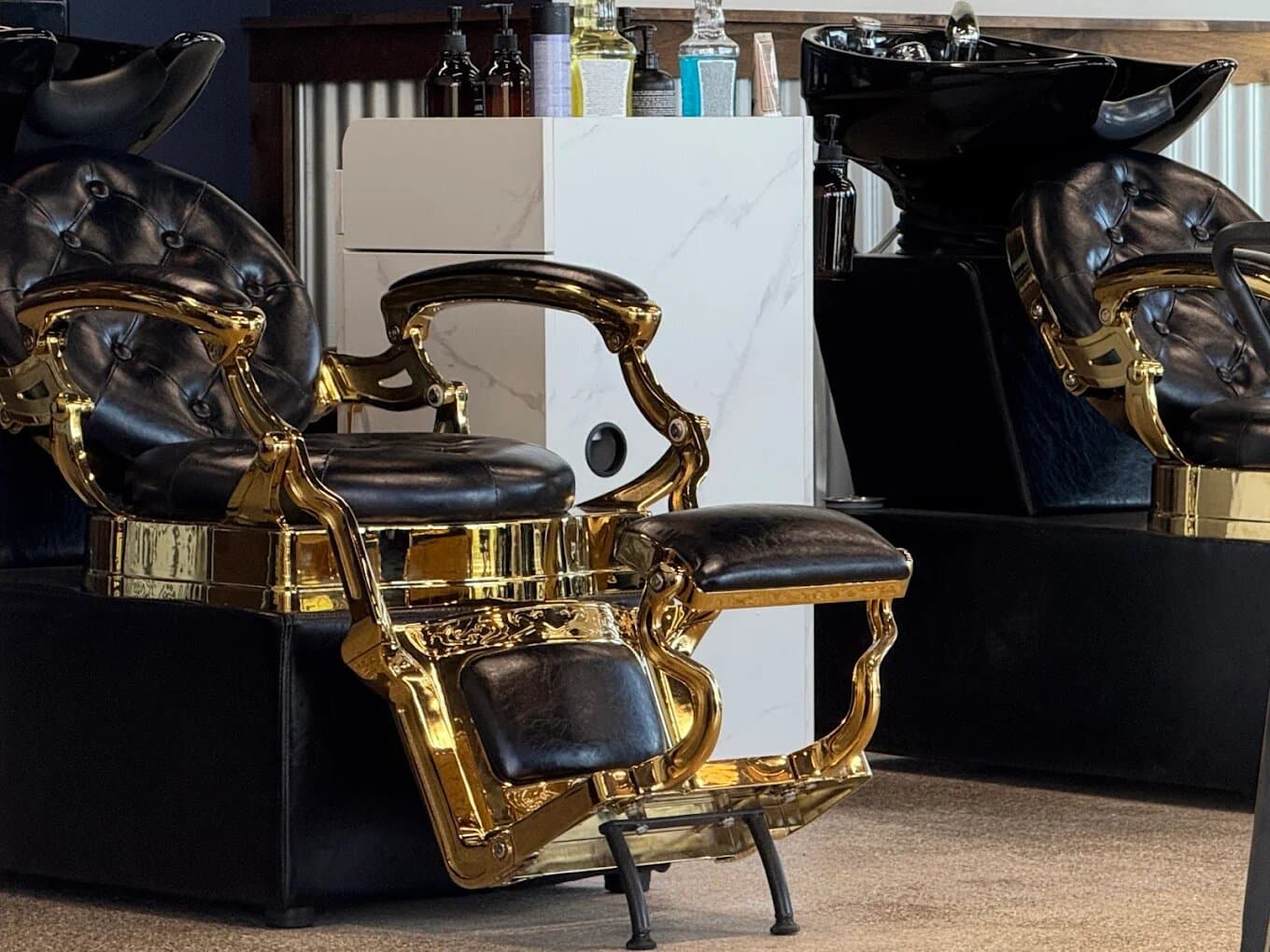 Signature black-and-gold barber chairs at Water Valley Barbershop