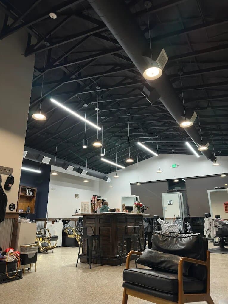 Vaulted interior of Water Valley Barbershop with styling chairs and pendant lighting